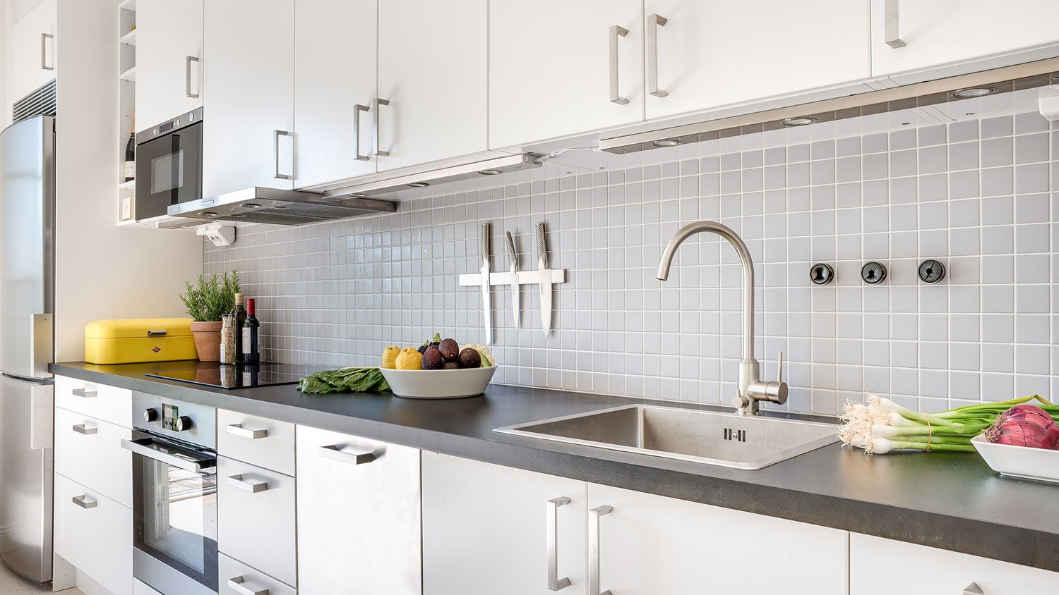 Slab kitchen cabinets with nickel hardware