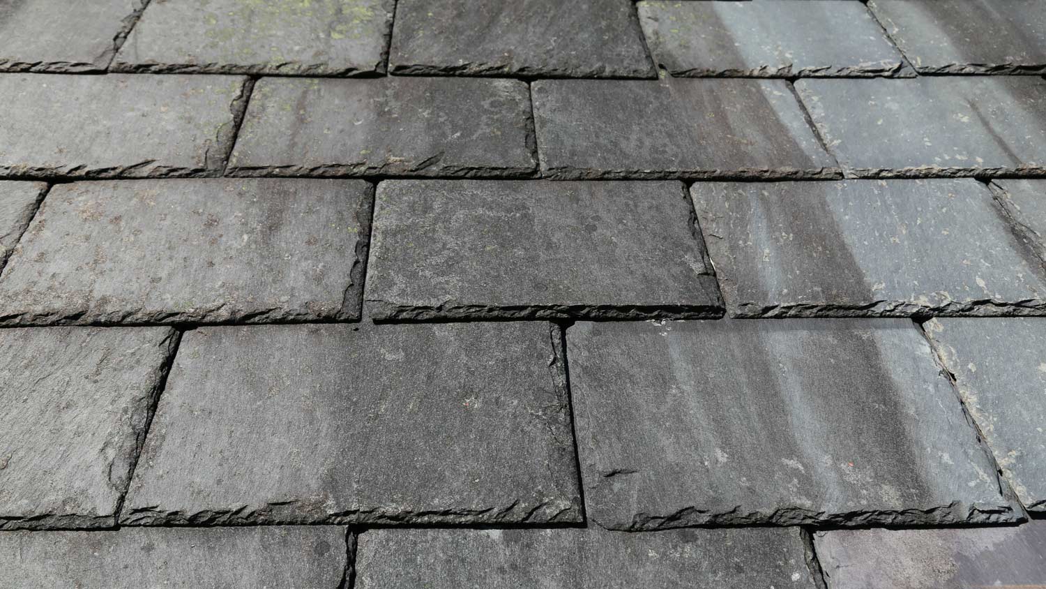 A close up view of some traditional slate tiles on a roof