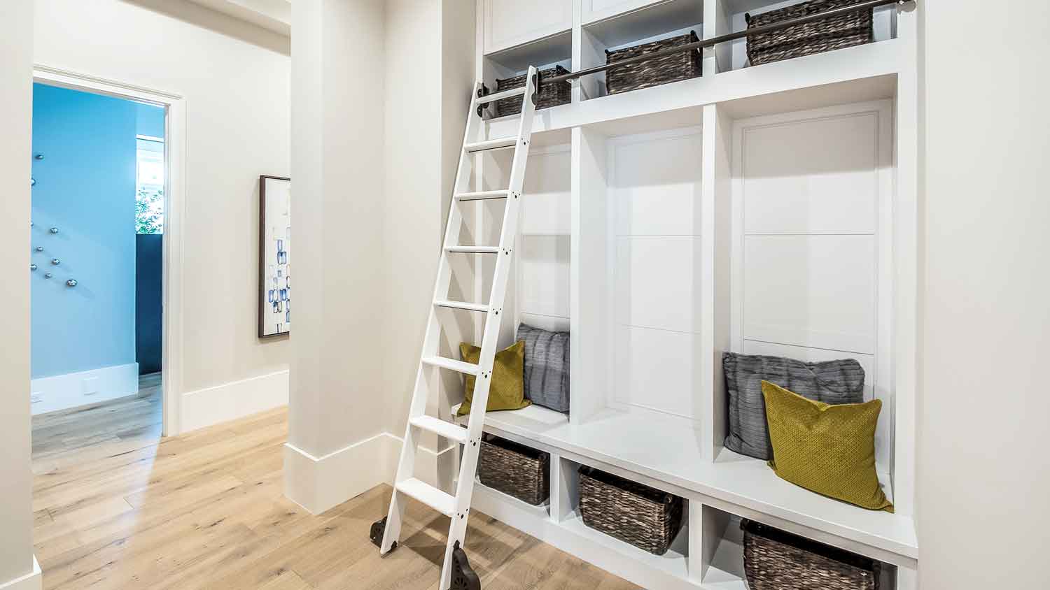 Mudroom with sliding ladder and built in shelves