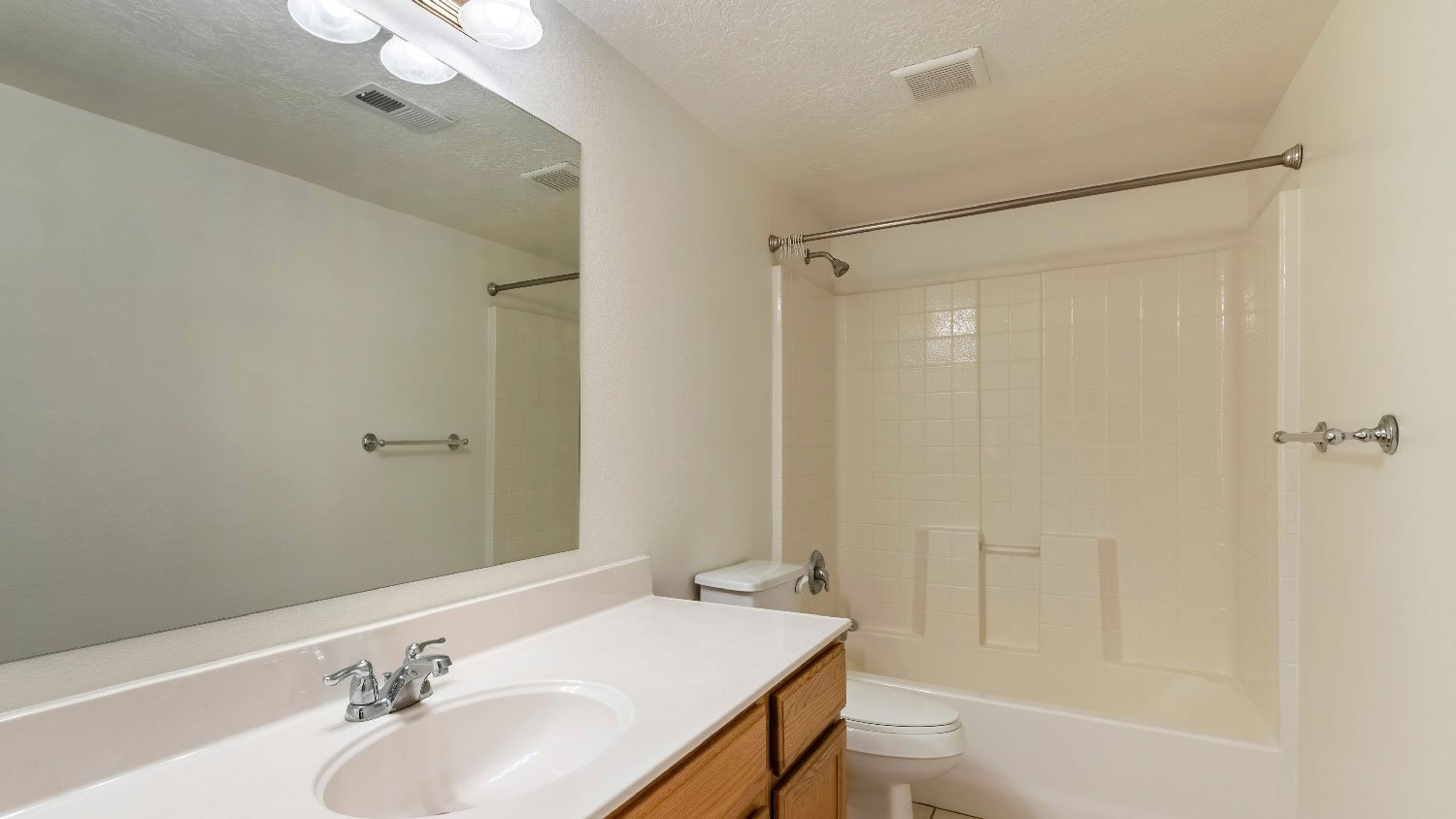 A small bathroom with an exhaust fan on the ceiling