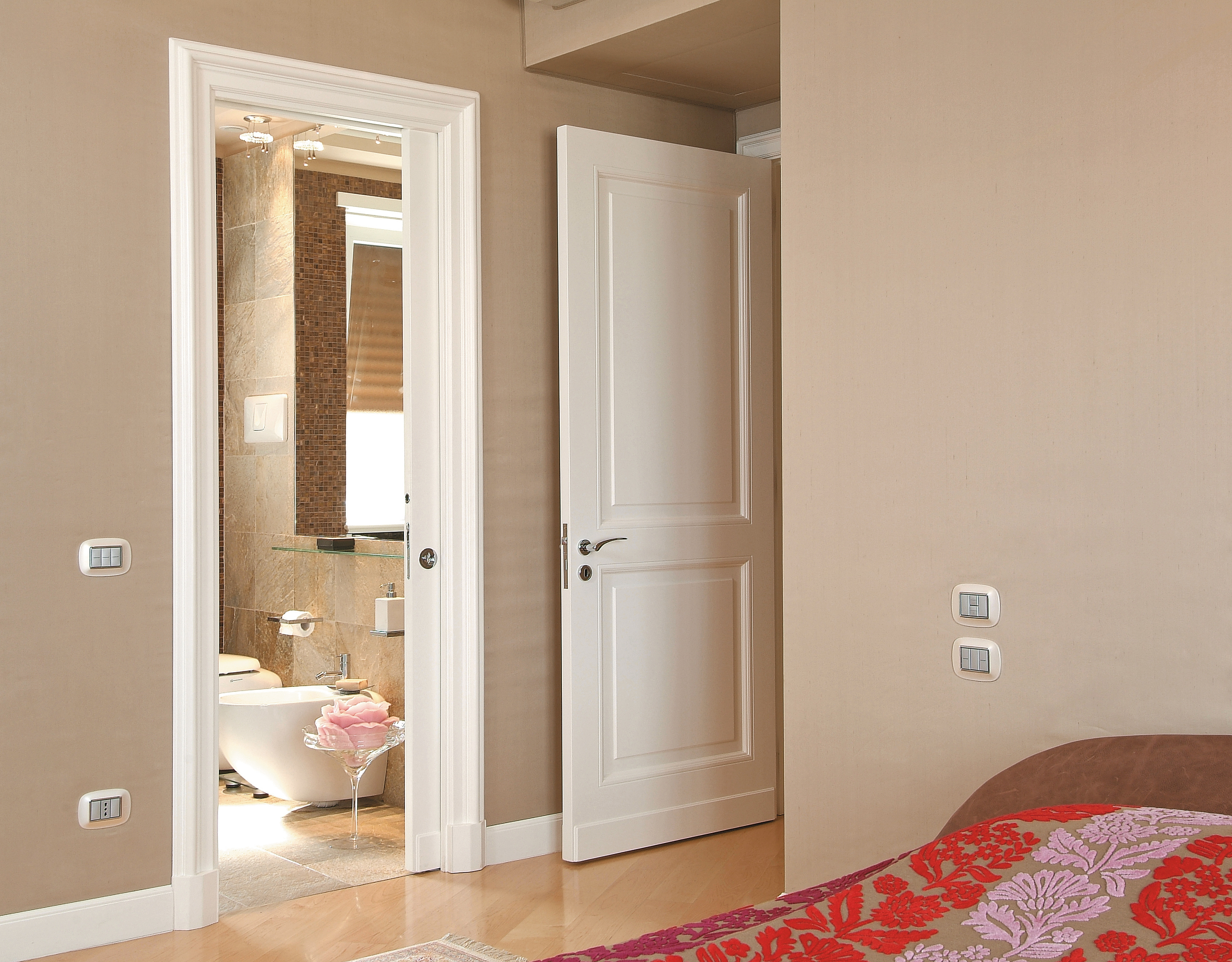 Beige bedroom with ensuite bathroom and open pocket door