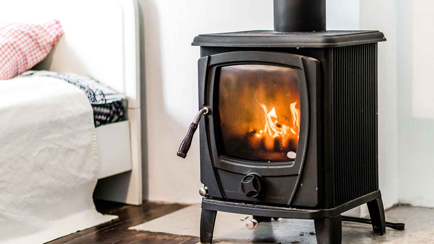 Small cast iron wood stove installed in the bedroom