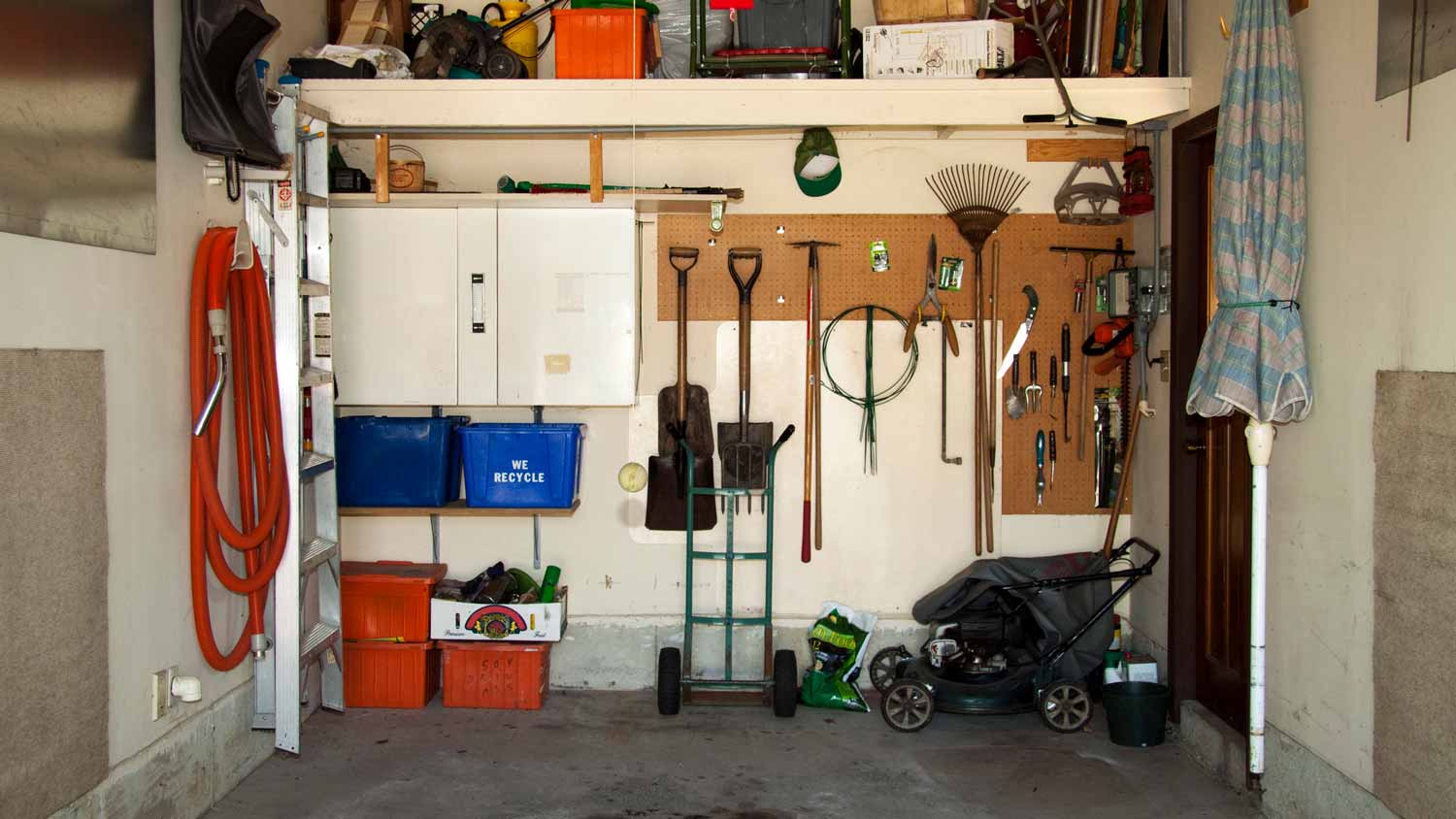 A small garage with tools on the wall