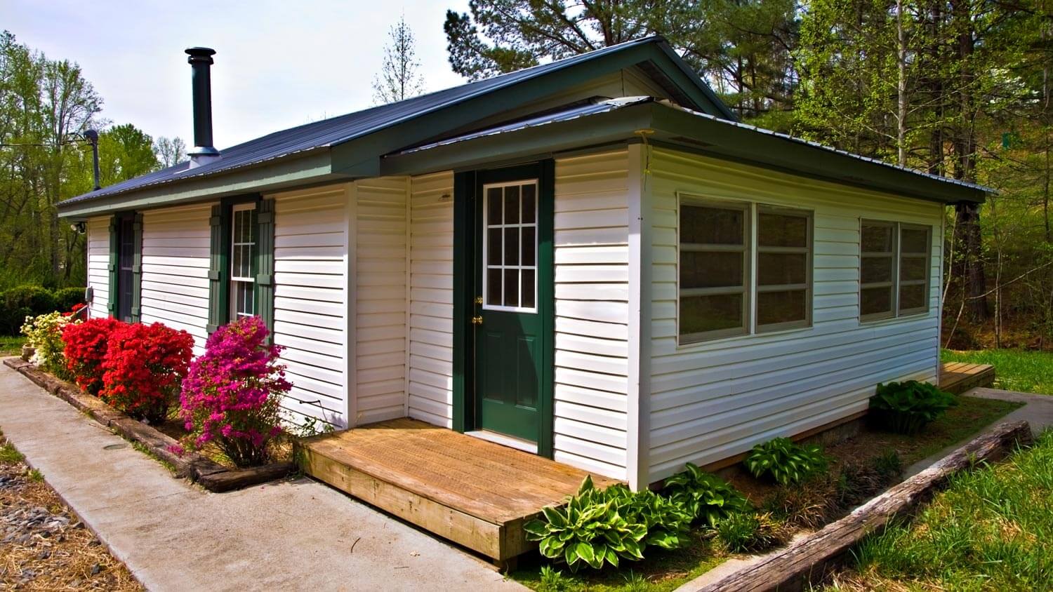 A small house with white metal siding