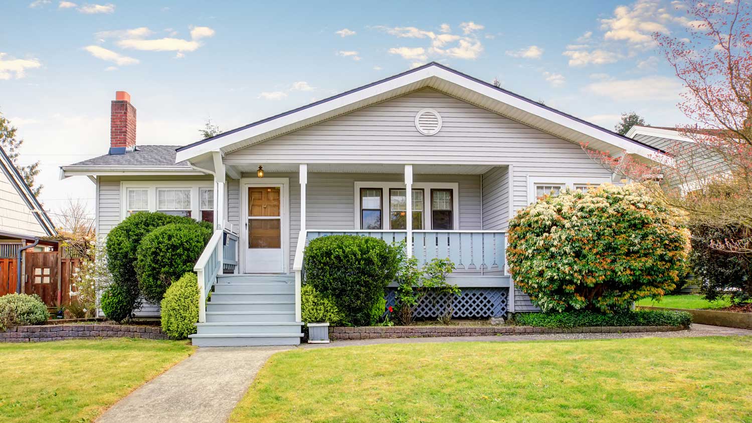 Small house with grey siding and white trim