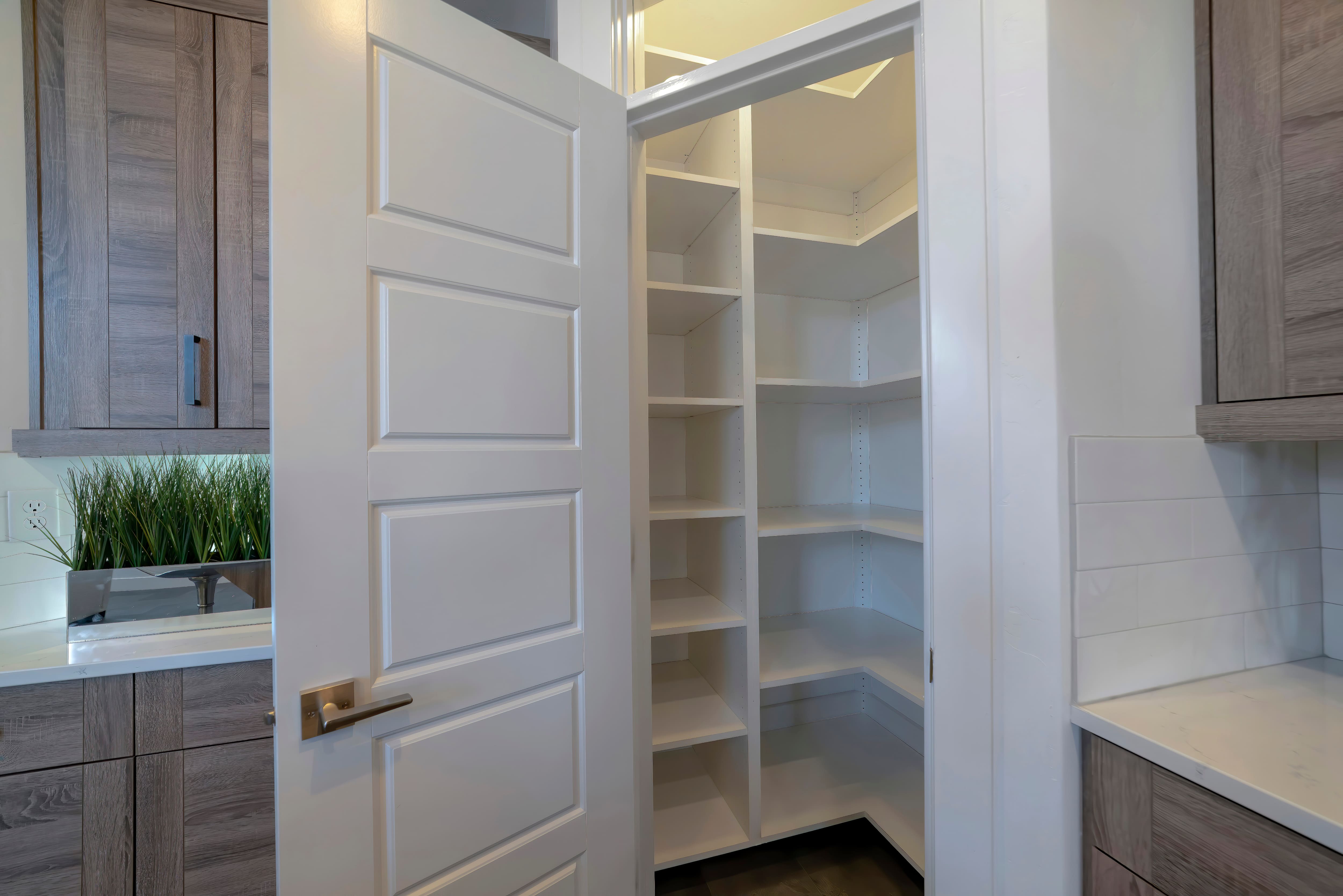 A small pantry with tall vertical shelves