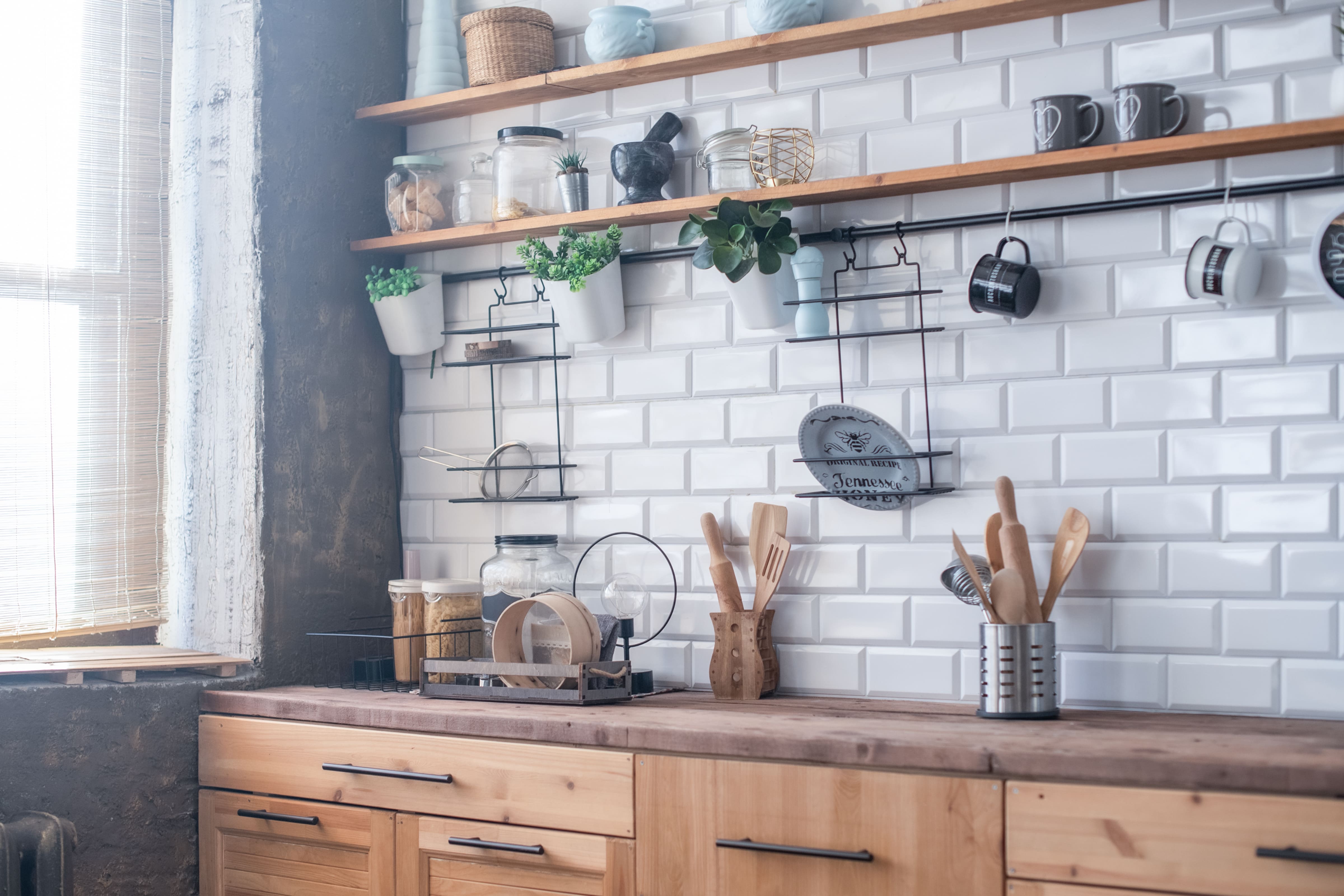 A small kitchen without upper cabinets and small open shelves