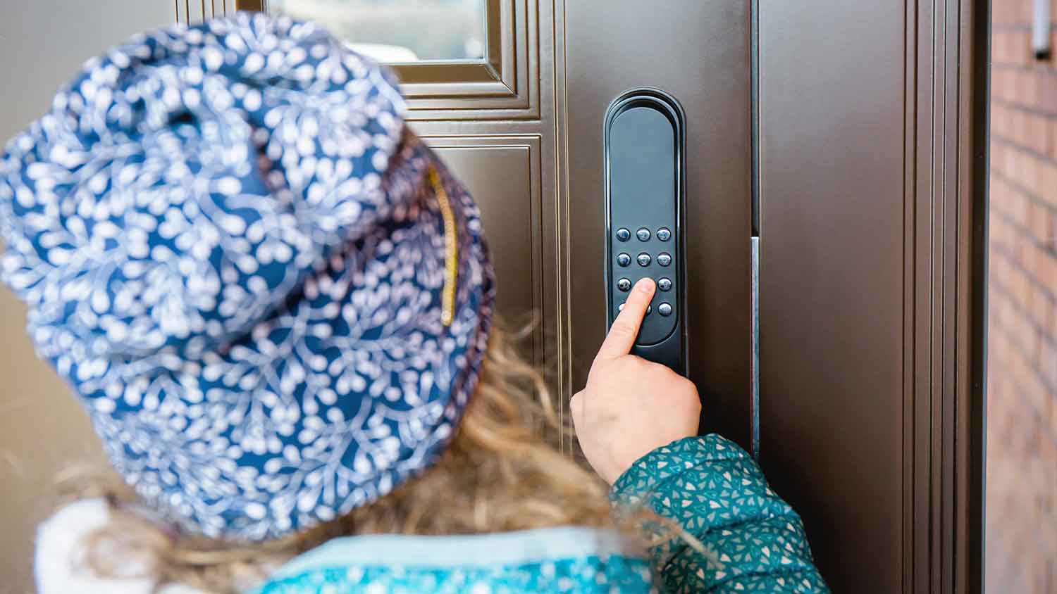 Girl unlocking door with a smart door lock