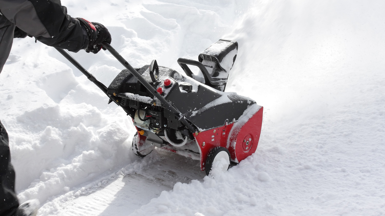 Man removing snow after storm with a snowblower 