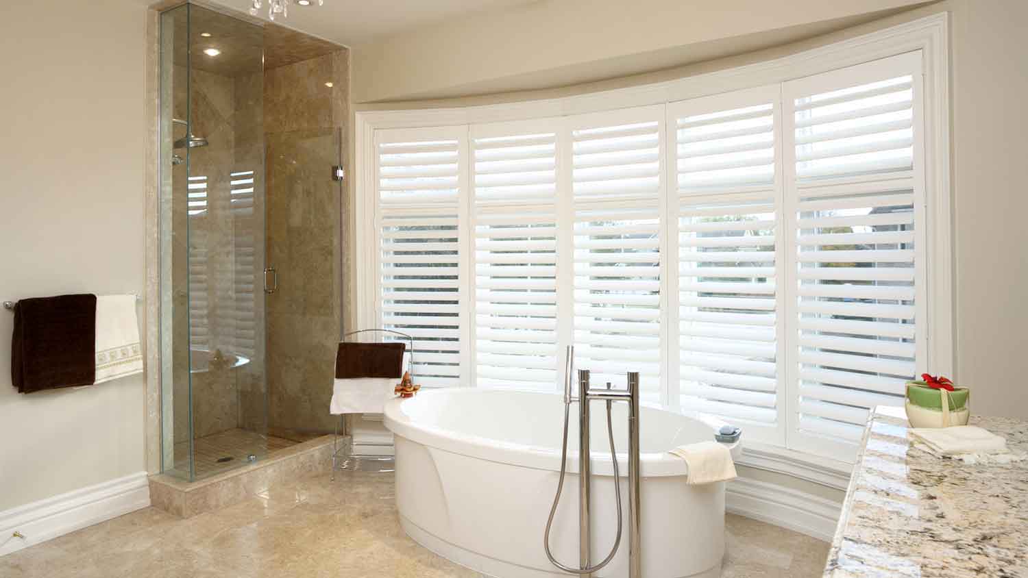 Spacious bathroom with large windows and a tub