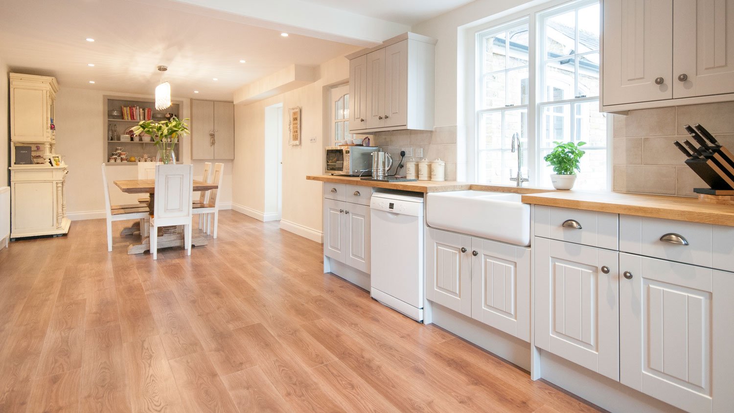 A spacious kitchen with white cabinets