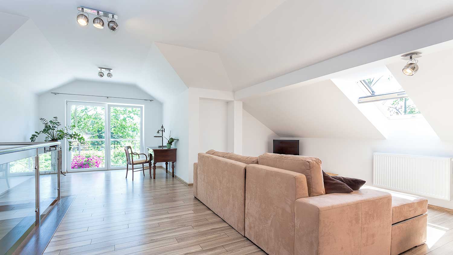 Spacious attic room with laminated flooring