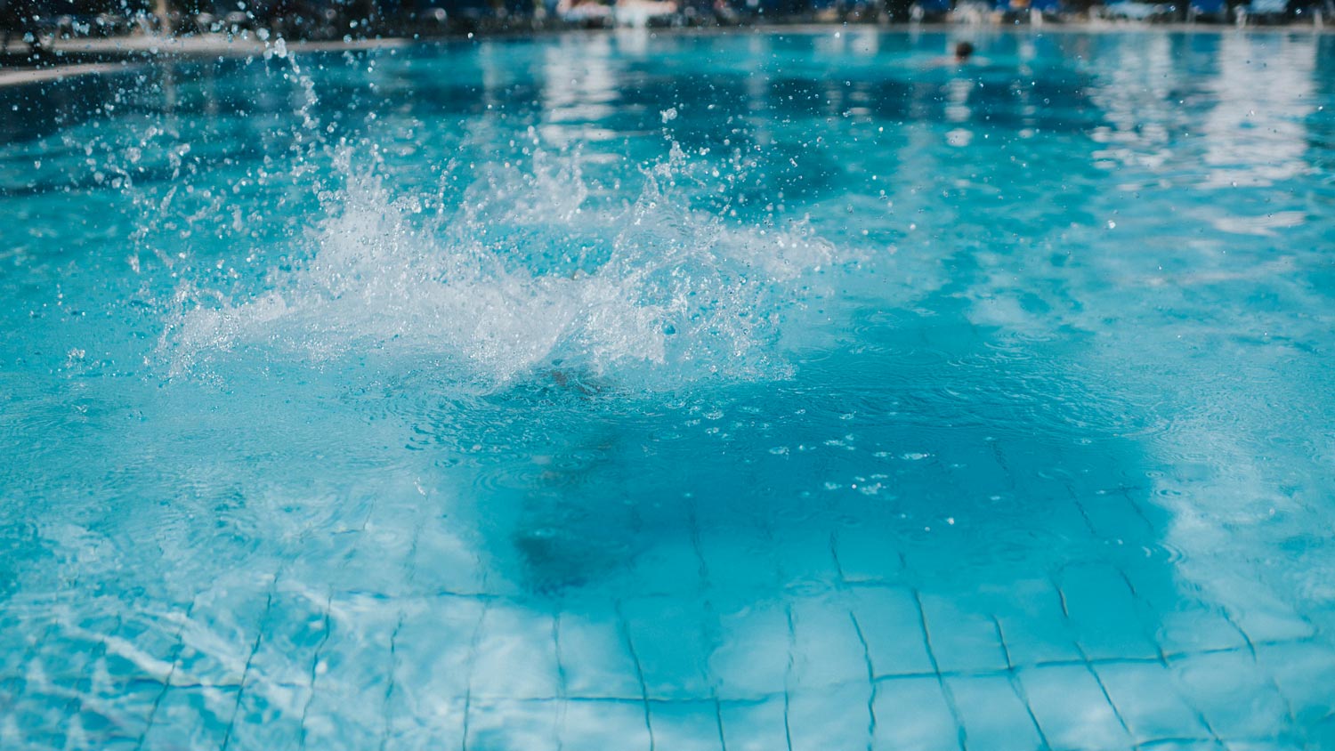 A splash created by someone jumping into a swimming pool