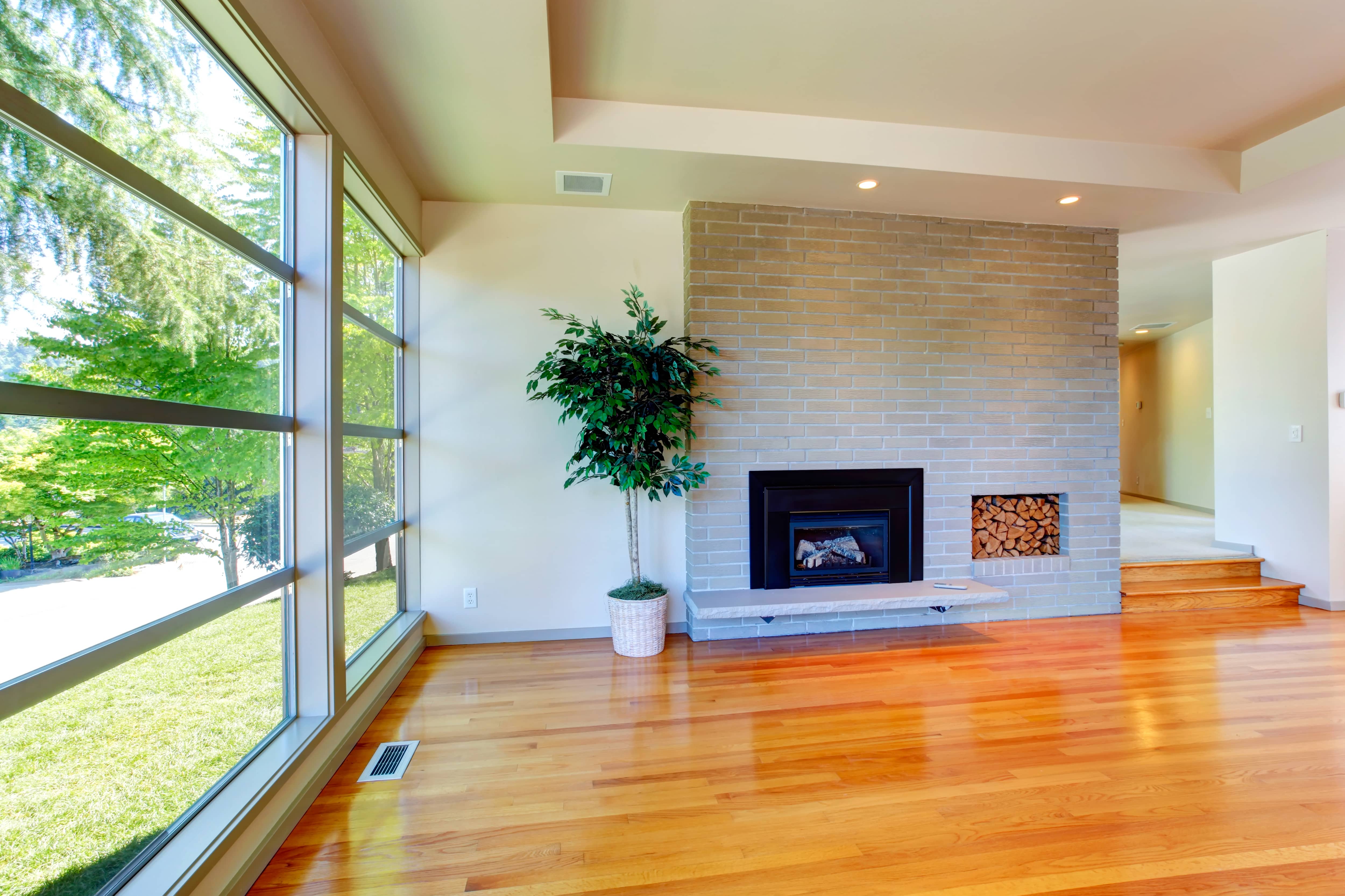 Modern gray brick fireplace with wall insert for wood