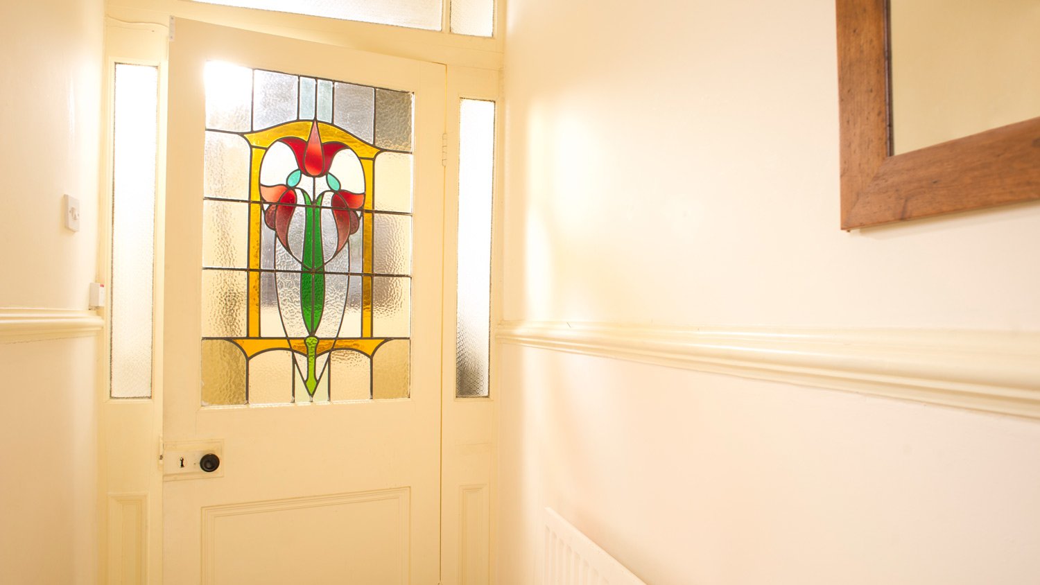 A porch door with stained glass on it