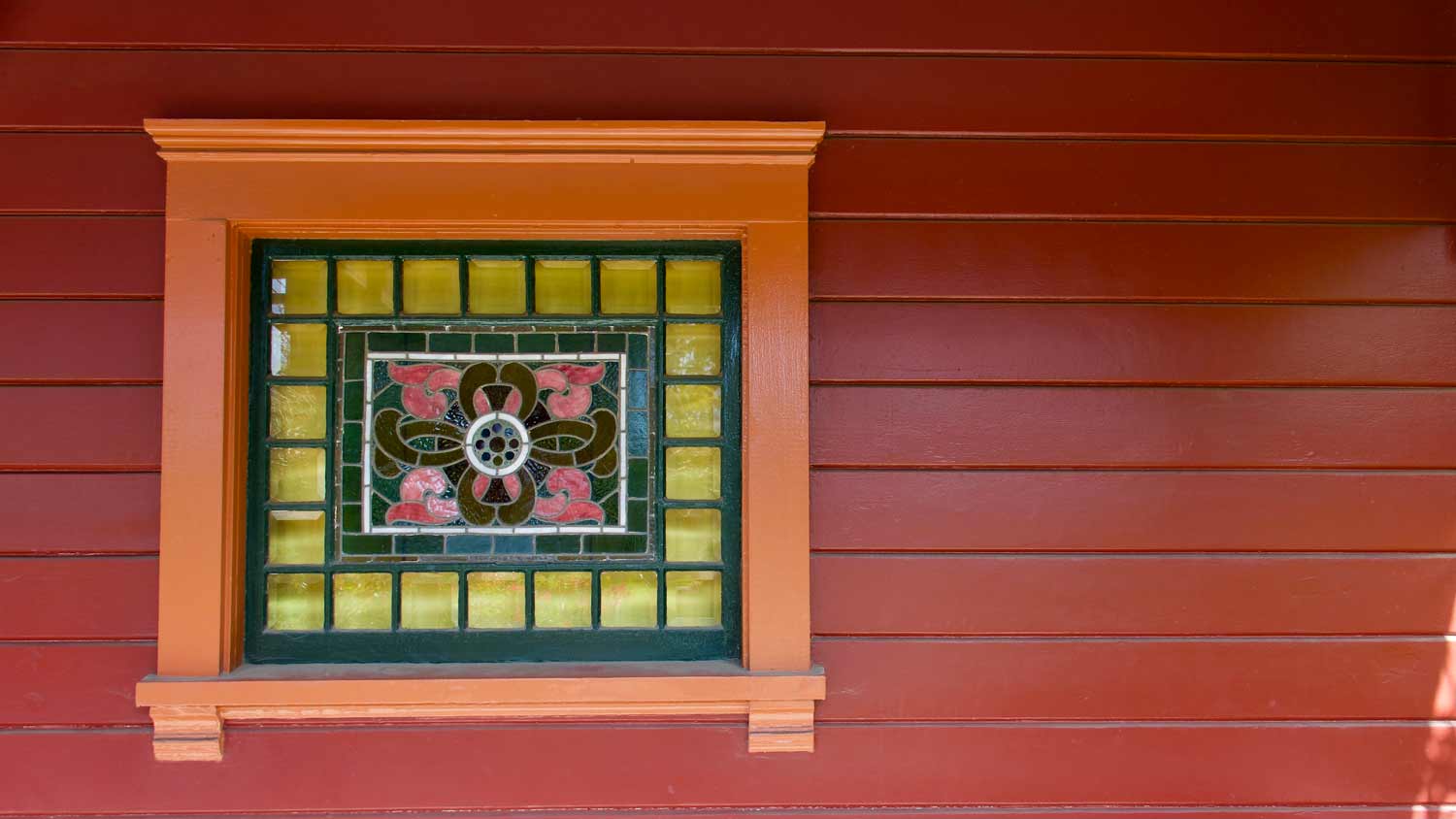 red house with stained glass window