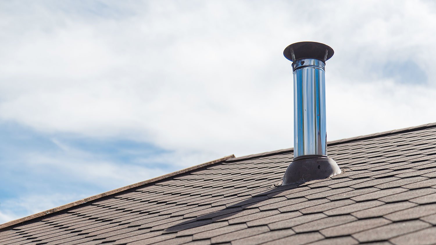 Chimney pipe on the roof of a house