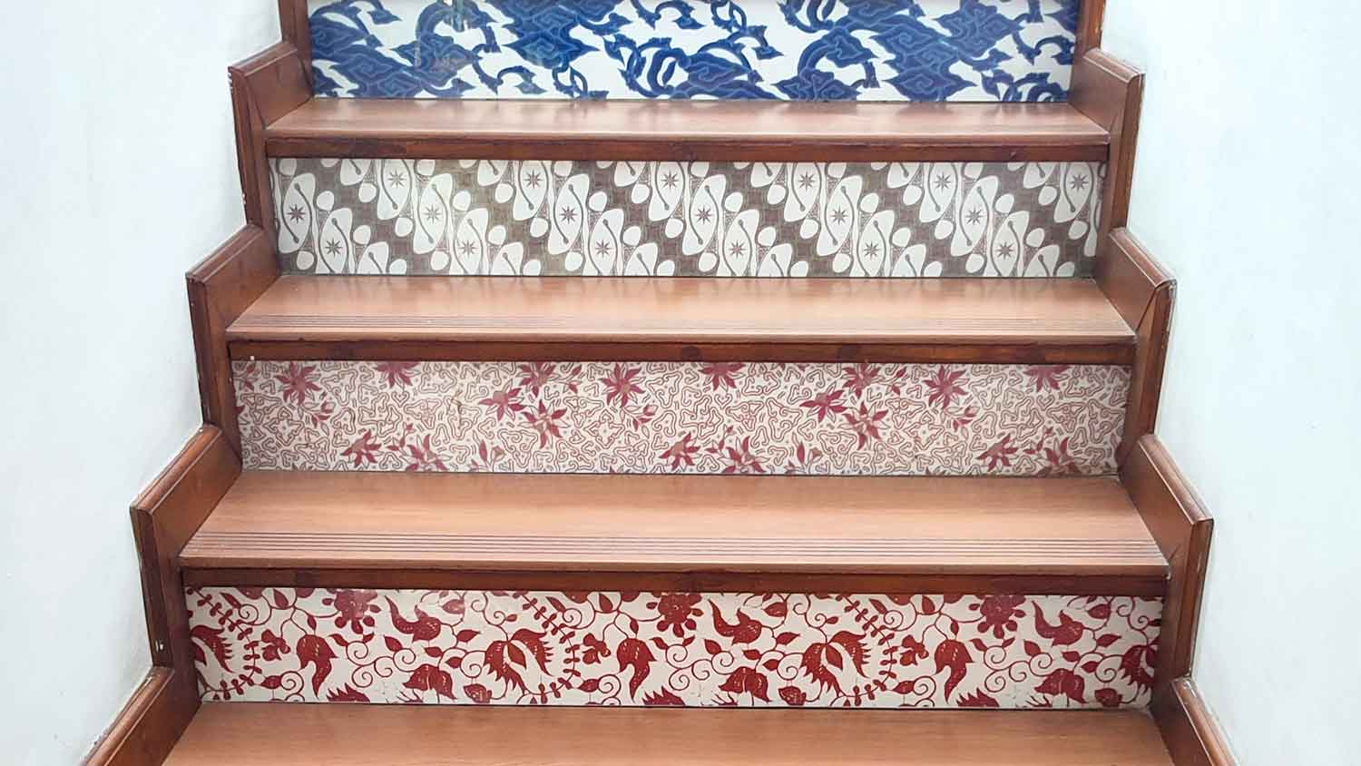 Wallpaper with various patterns installed on staircase risers 