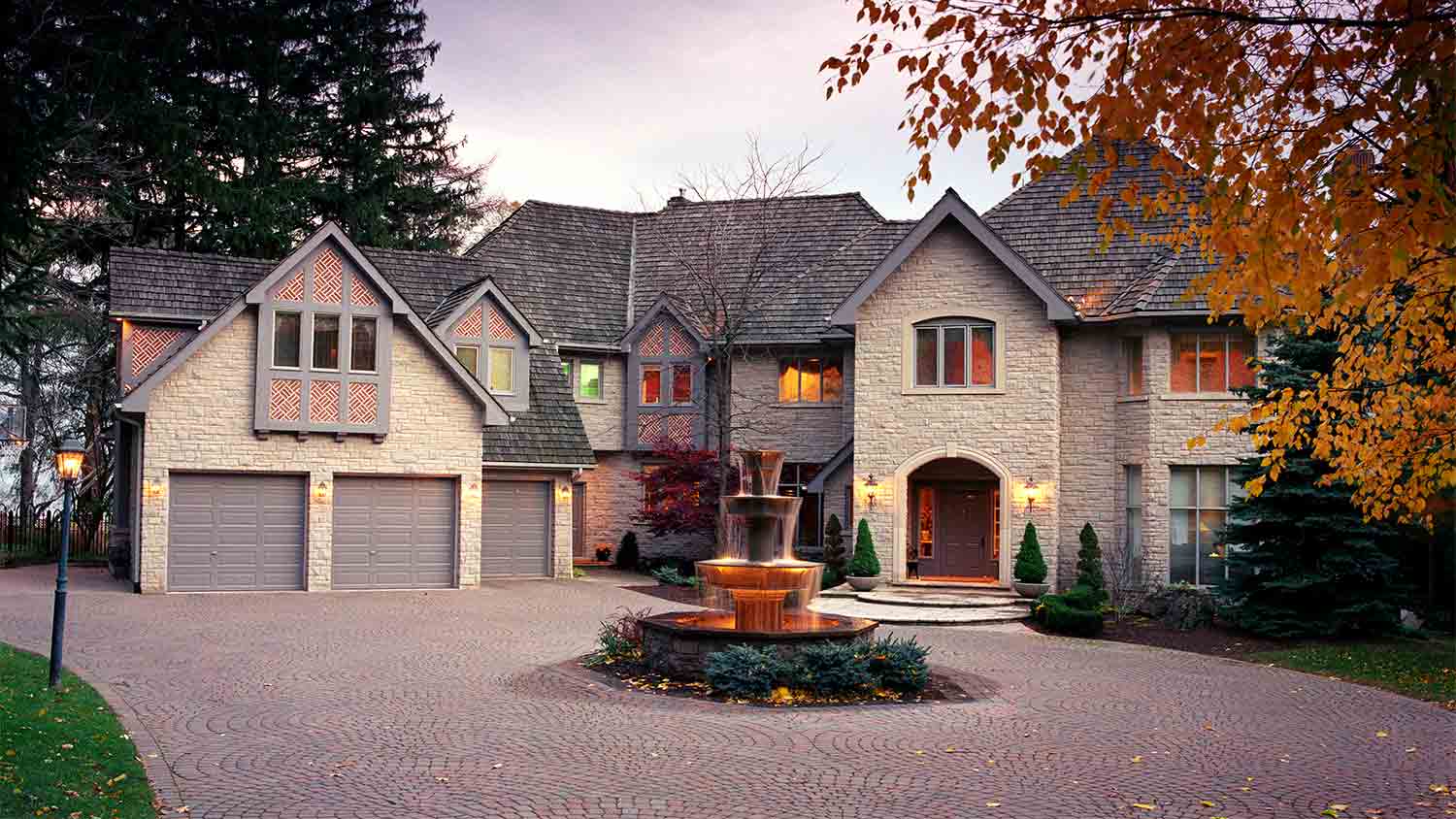 large mansion with stamped concrete driveway