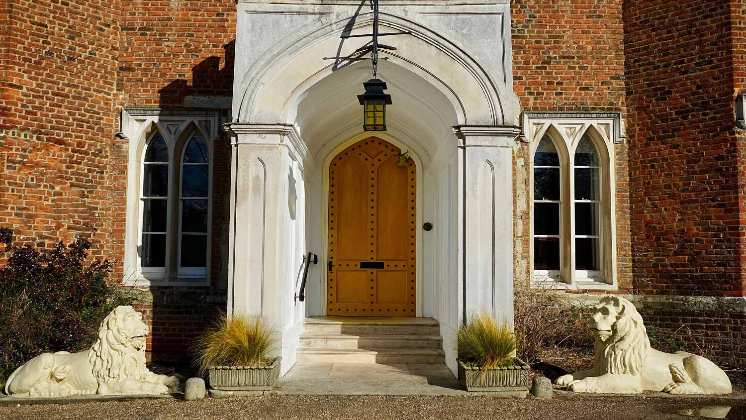 A historic front porch with lion statues