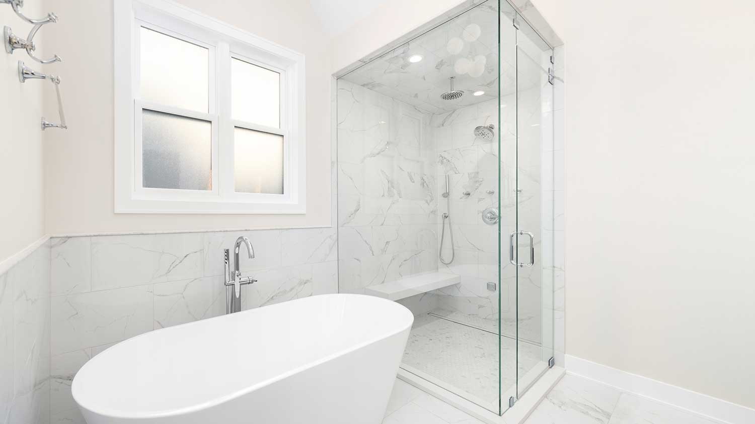 White tile bathroom with steam shower door