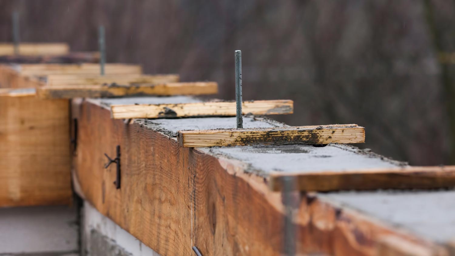 Close-up of steel bar reinforcements on block foundation