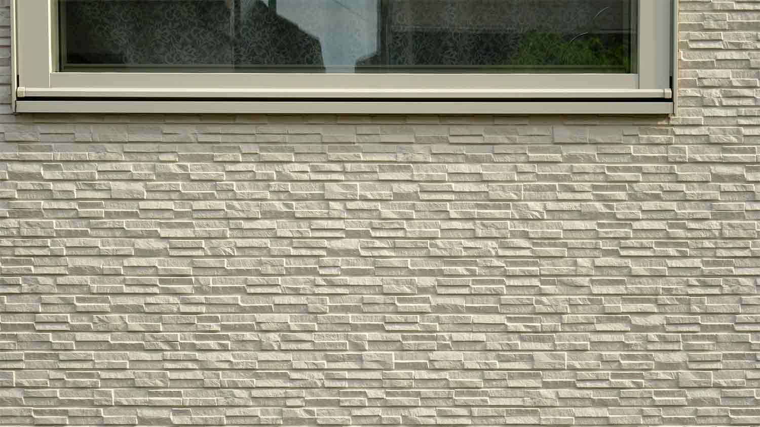 beige stone veneer siding of home