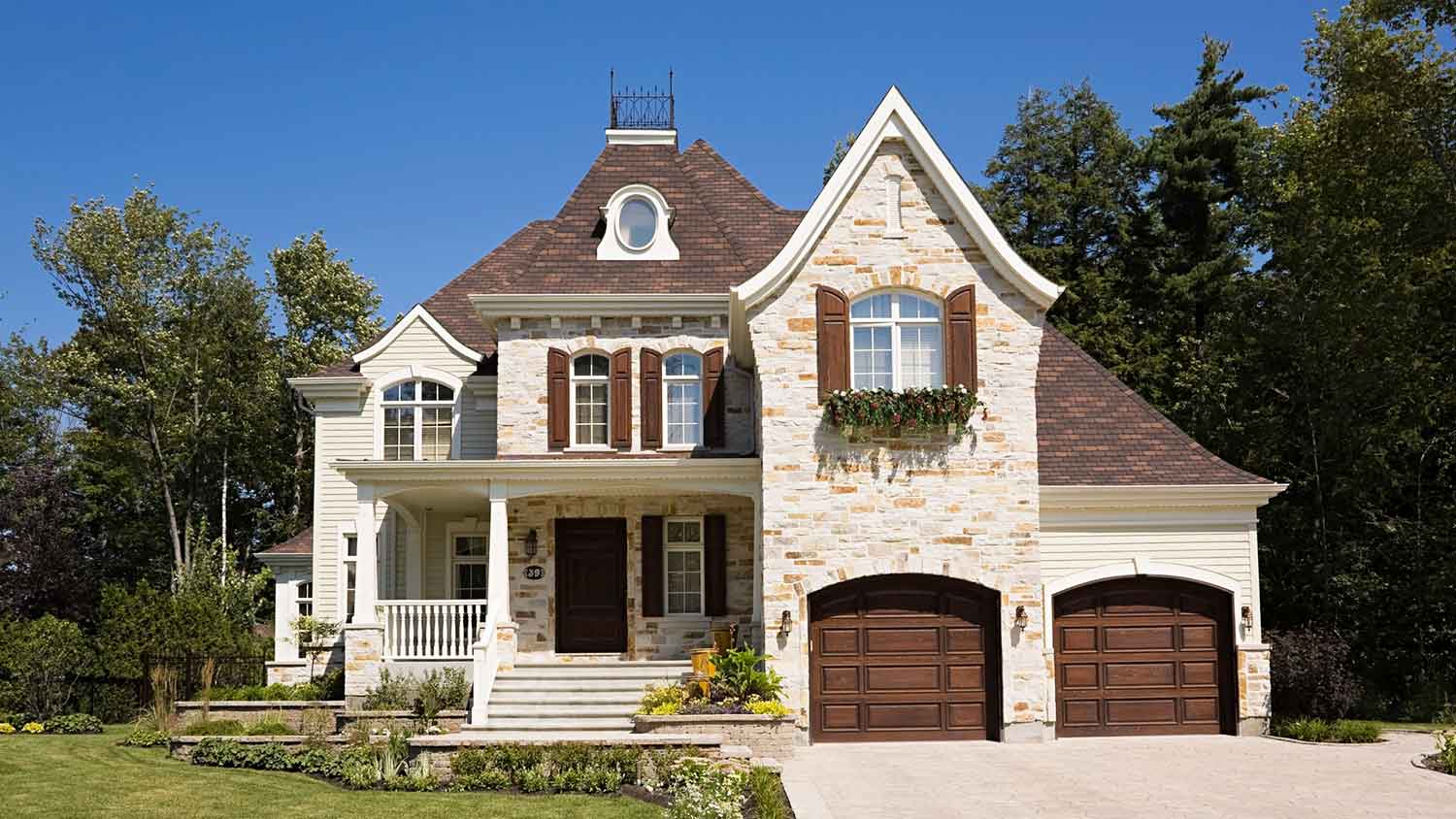 House with stone siding and brown window shutters