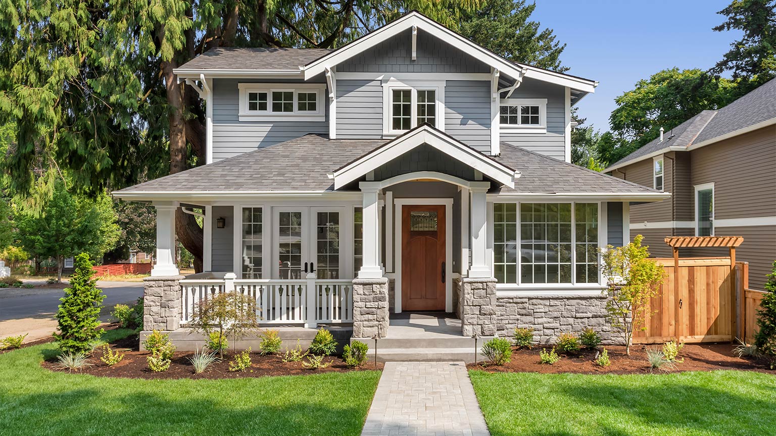 luxury home exterior with walkway, covered porch, and stately gables and columns