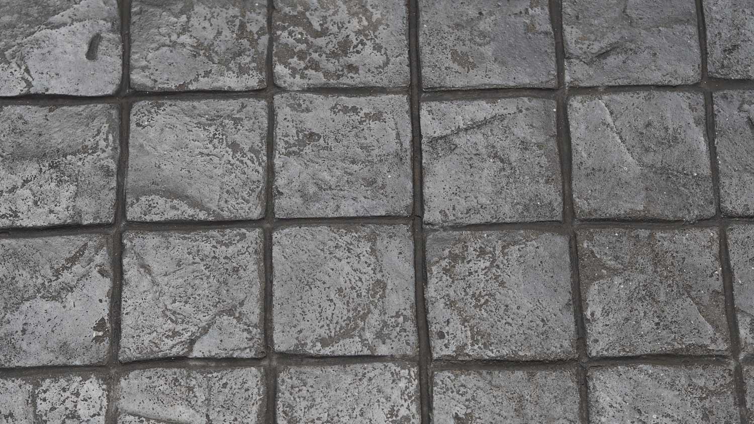 Stamp concrete black grey color hardener printing patterns on the cement