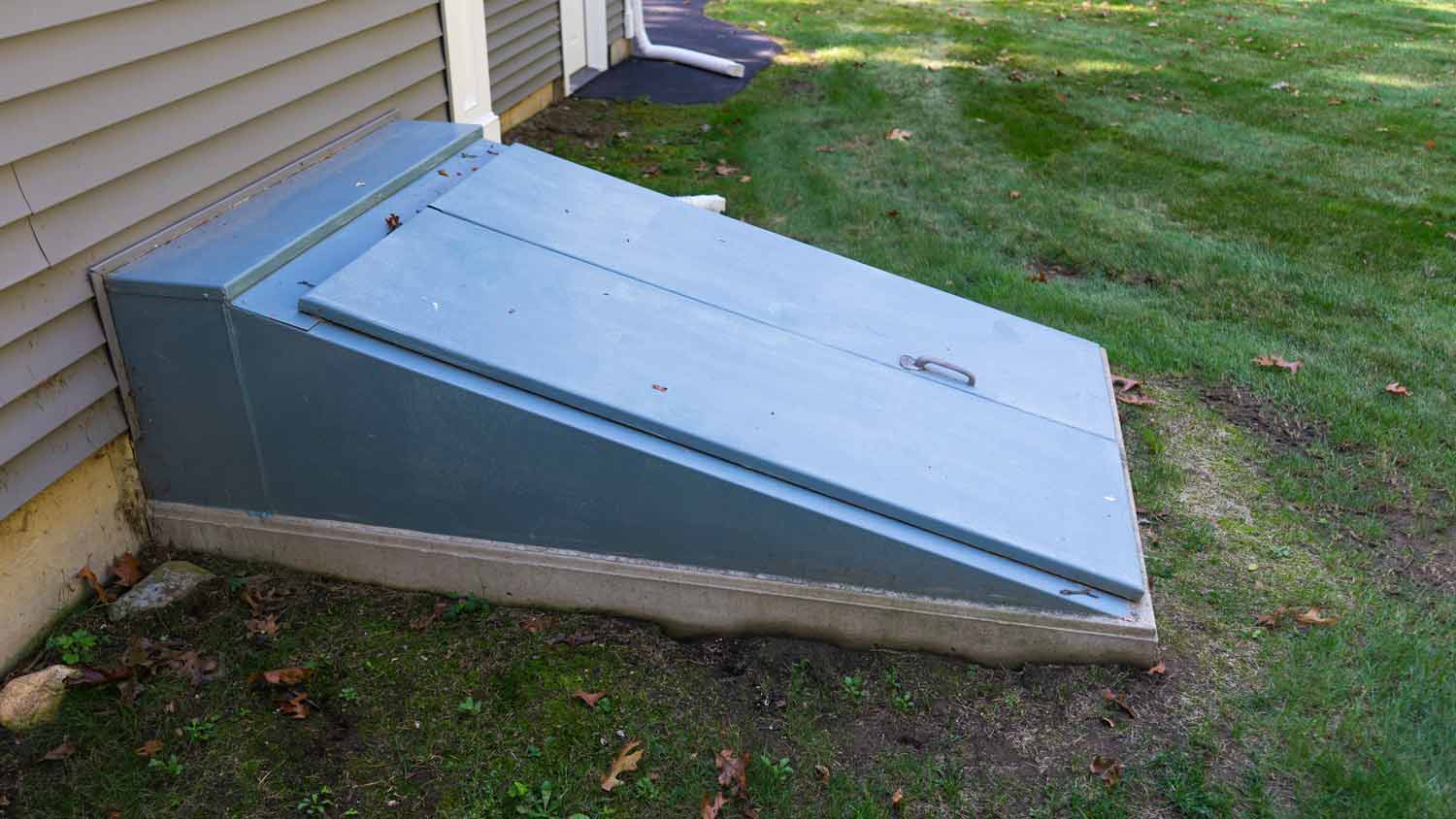 blue storm shelter doors outside home