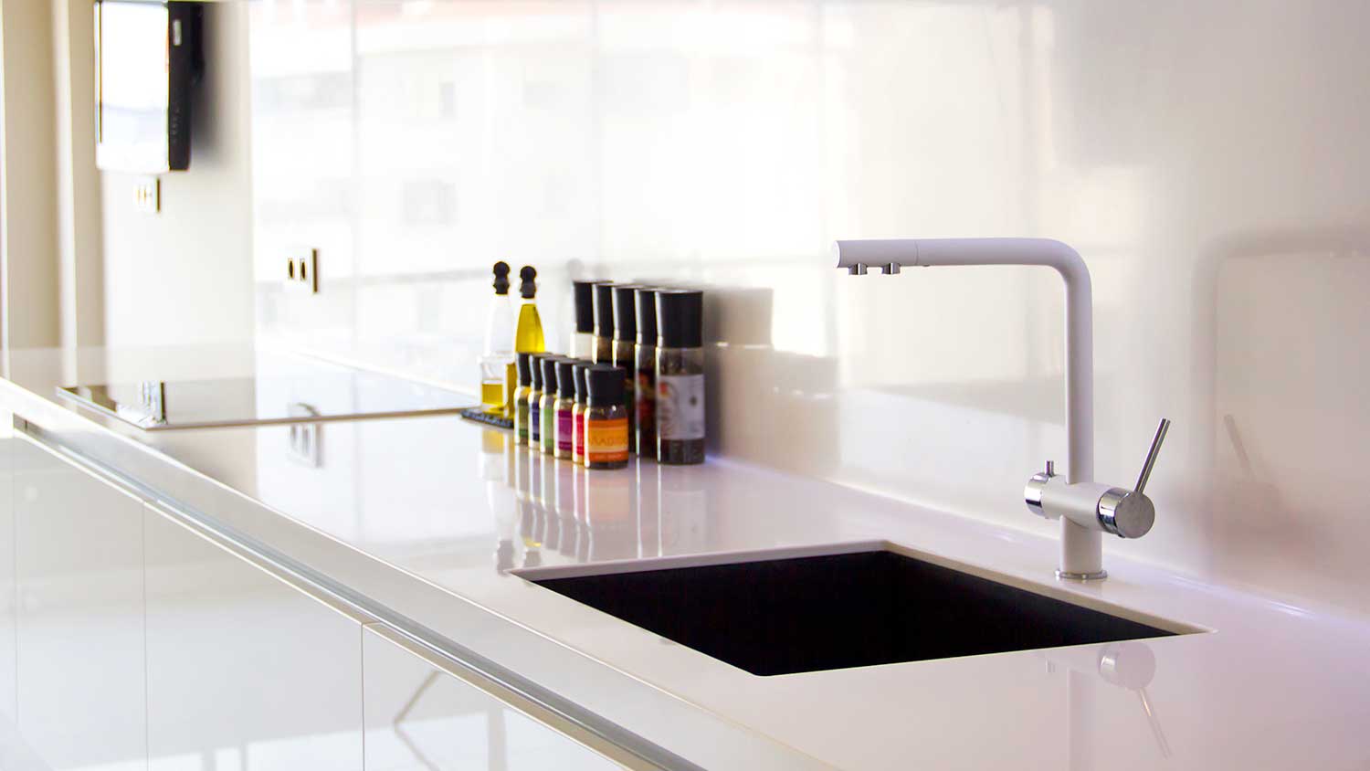 Modern white kitchen with straight spout faucet