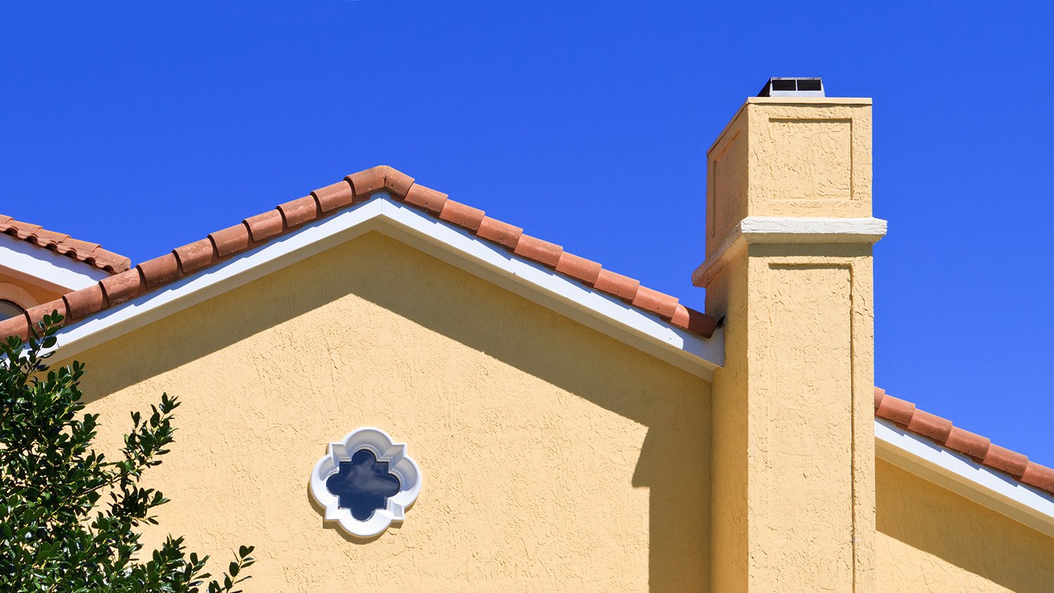 Roof of a house with a stucco chimney