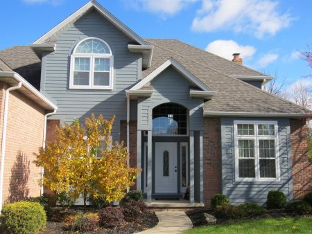 a house with a tree and fiber cement siding