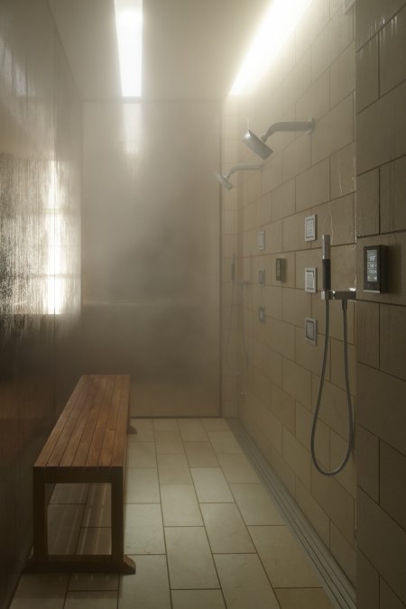steam shower with bench and controls on wall
