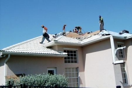 roofers ripping off old tile roof