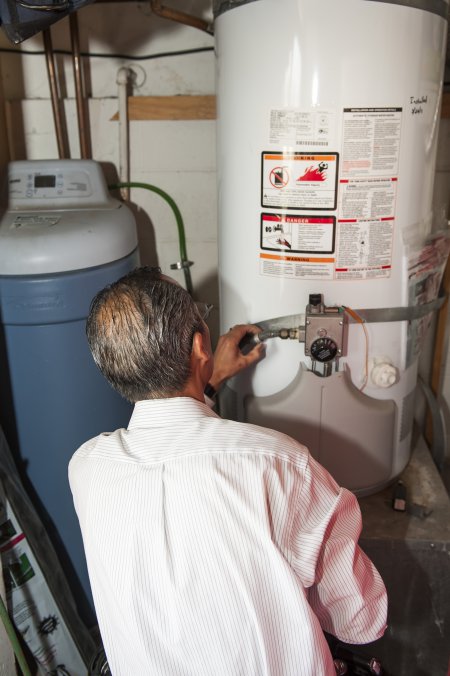 home inspector looking at water heater