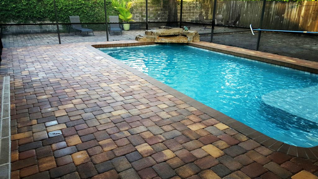Pool with lanai and brick patio