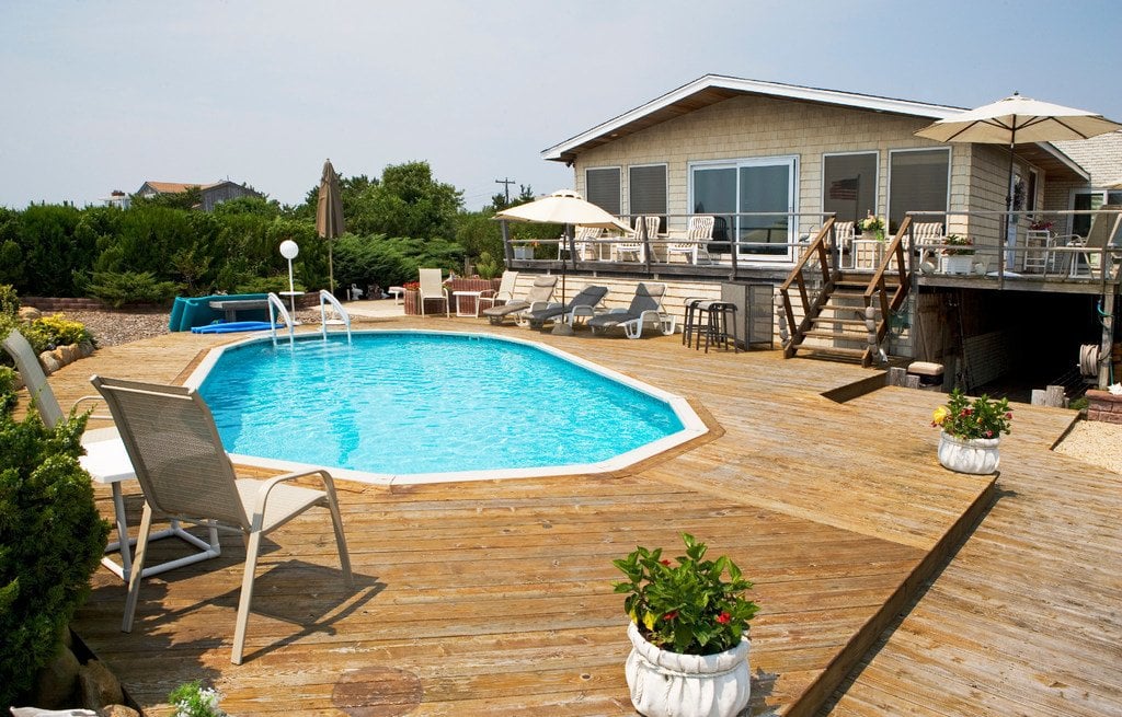 In-ground pool with wooden deck at beach house