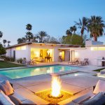 Pool with spa areas and fire pit with couch