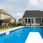 Pool with diving board, basketbal goal and fountains