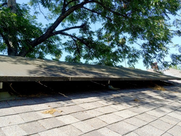 Solar roof panels positioned in partial shade.