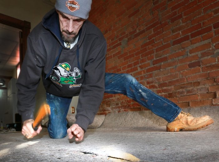 carpet pad installation (Photo by Frank Espich)