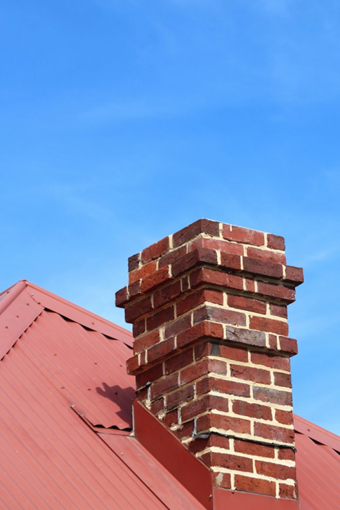 chimney on roof under blue sky
