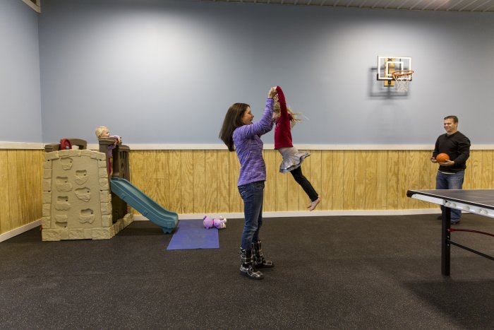 family playing in pole barn recreation room