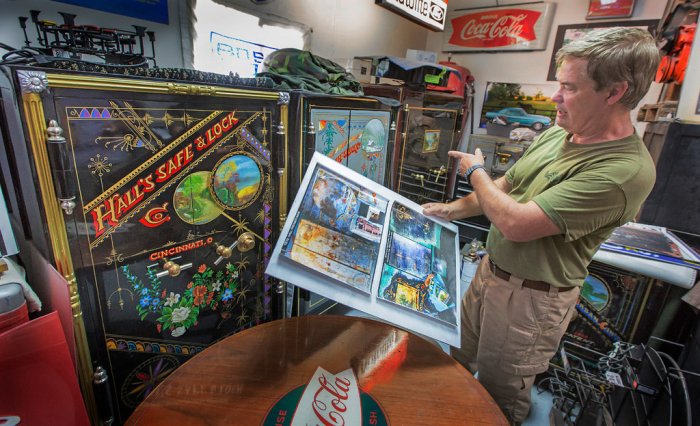 Billy Jay Espich shows to Hall's Safe & Lock Co. safes that he restored, both with Asian-influenced floral designs