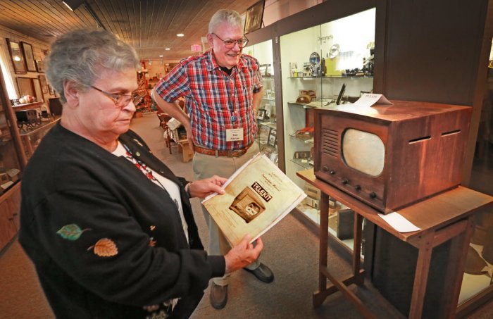 Pendleton Historical Society volunteers Barbara and Rex Mercer with a 1948 TV set.