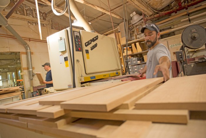 Taggart Construction employees work with lumber at their Maine shop