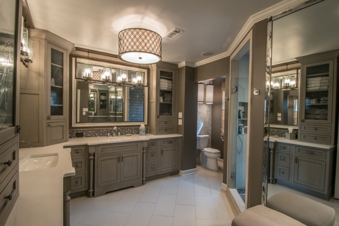 high-end master bathroom with custom cabinets, tile, lighting and mirrors