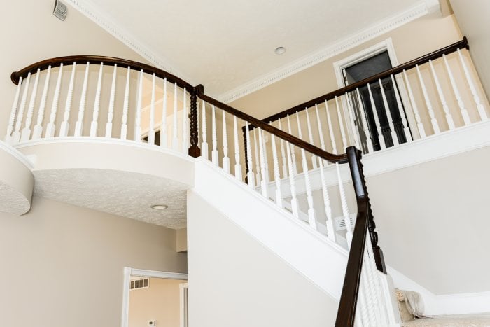 stairway balcony black rail white stairs entry in foyer (Photo by Summer Galyan)